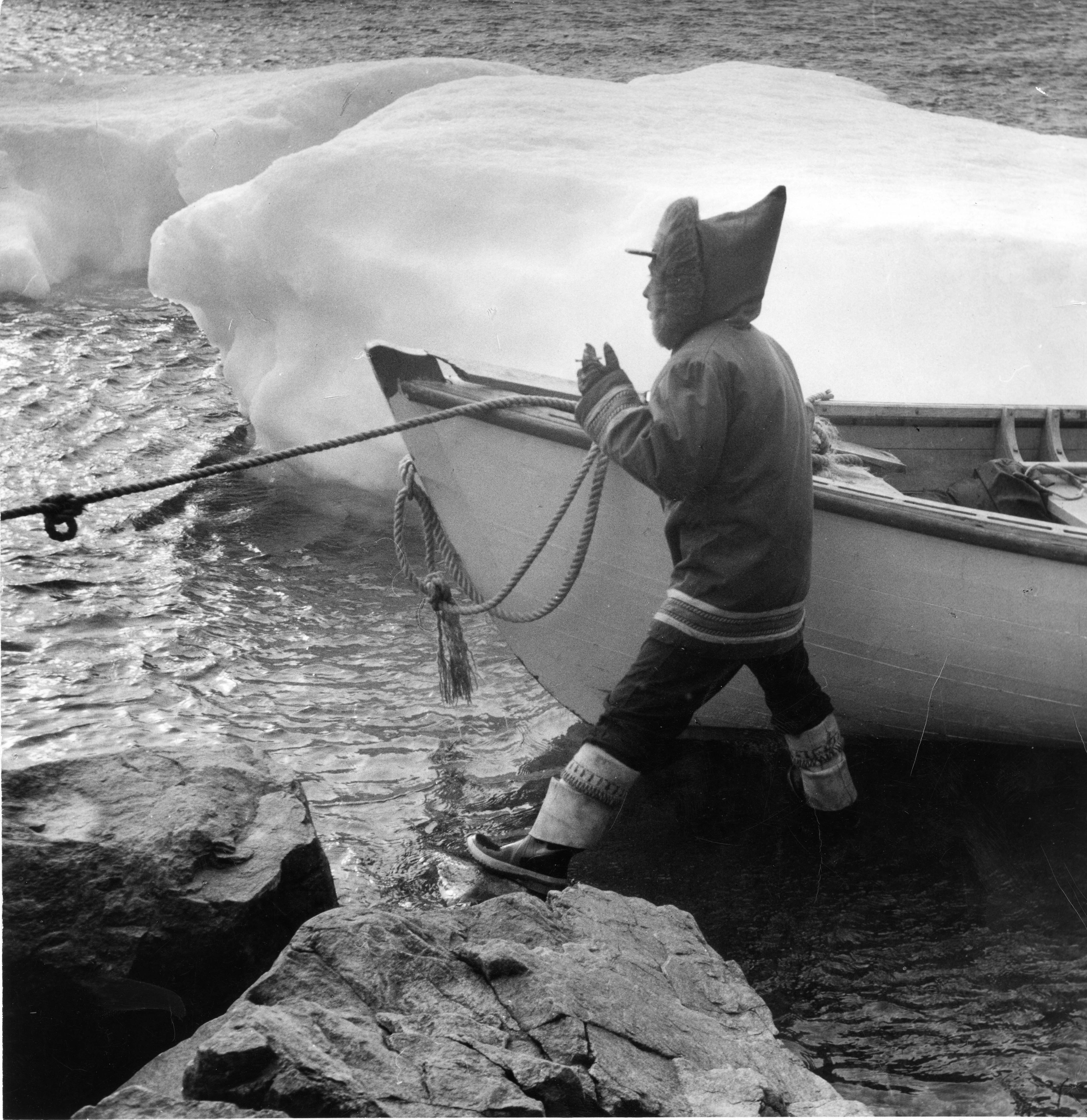 Photo of Mosesee standing next to a boat