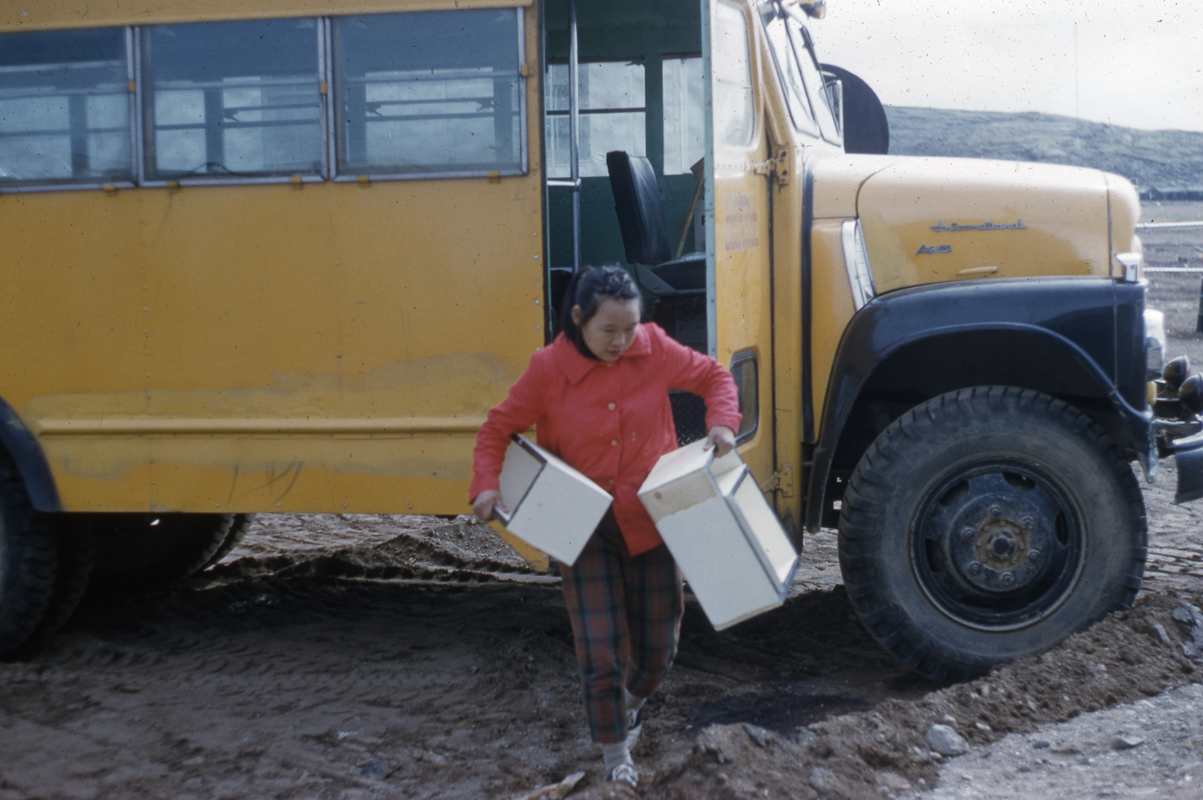 Woman exiting yellow bus